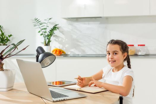 Kids distance learning. Cute little girl using laptop at home. Education, online study, home studying, technology, science, future, distance learning, homework, schoolgirl children lifestyle concept.