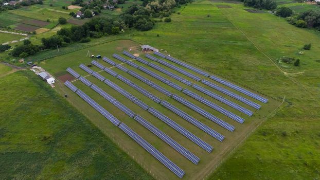 Aerial view of Solar Panels Farm solar cell with sunlight. Drone flight over solar panels field, renewable green alternative energy concept