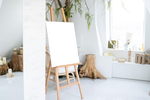 Easel with painting in artist's workshop.