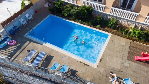 A mother and daughter playing in the pool.