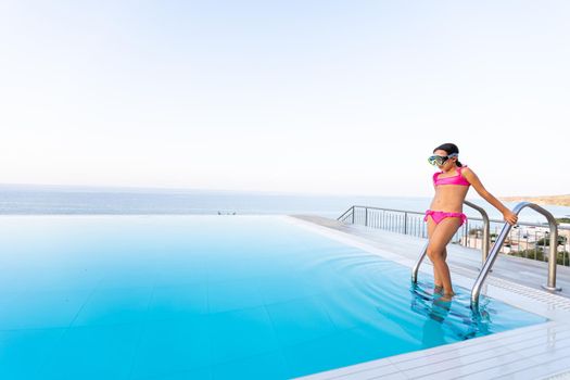 Young girl posing near swimming pool