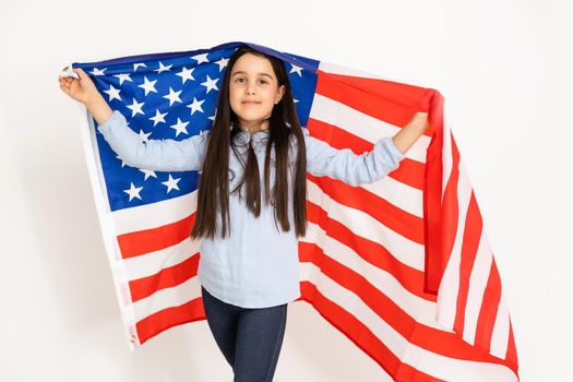 Patriotic holiday. Happy kid, cute little child girl with American flag. USA celebrate 4th of July