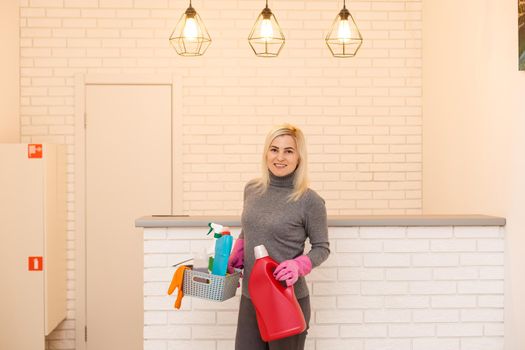 Women at work, portrait of happy professional female cleaner smiling and looking at camera in office.