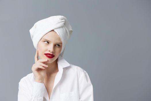 pretty woman white shirt cosmetics with towel on head studio model unaltered. High quality photo