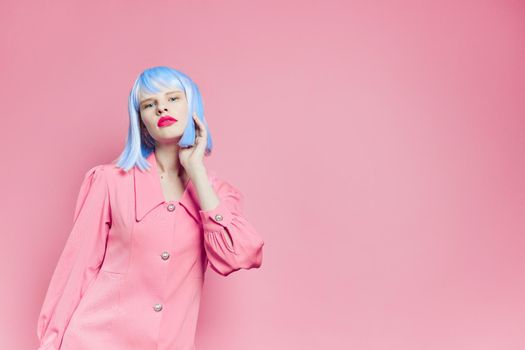 fashionable woman in blue wig pink dress red lips isolated background. High quality photo