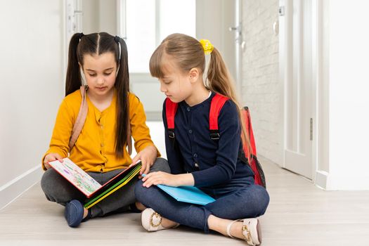 elementary school girls walking in classroom building