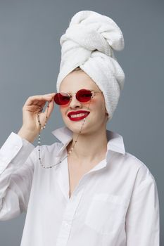 woman with a towel on his head in a white shirt studio model unaltered. High quality photo