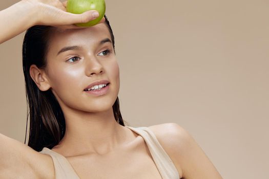 young woman happy smile green apple health beige background. High quality photo