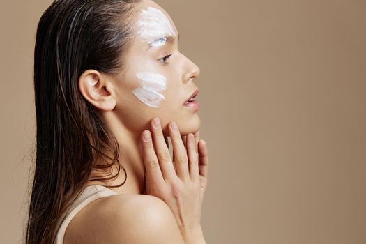 young woman applying a soothing face mask cosmetic close-up make-up. High quality photo