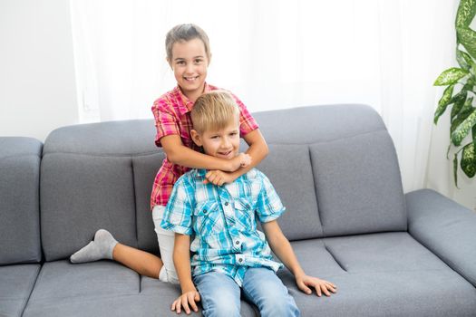 Happy brother and sister embracing each other.