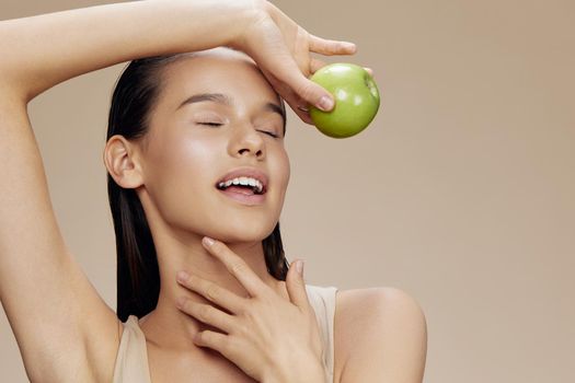 beautiful woman apple in hands posing fruit healthy food fresh beige background. High quality photo