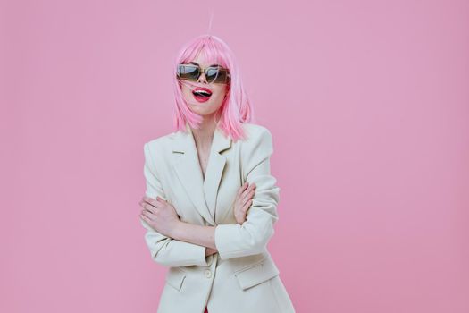 Portrait of a charming lady wearing sunglasses pink hair posing color background unaltered. High quality photo