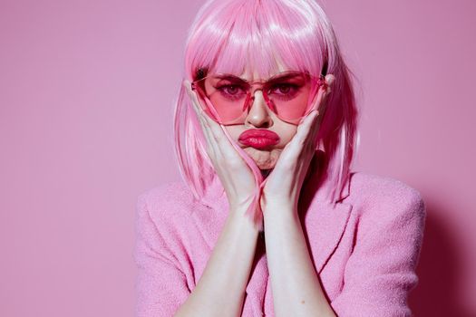 Beautiful fashionable girl bright makeup pink hair glamor stylish glasses color background unaltered. High quality photo