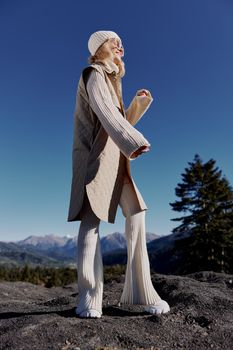 Stylish woman Cliffs mountains fashion posing nature fresh air lifestyle. High quality photo