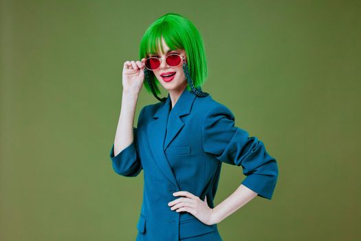 woman in green wig stylish glasses fashion posing green background. High quality photo
