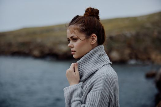 woman sweaters cloudy sea admiring nature unaltered. High quality photo
