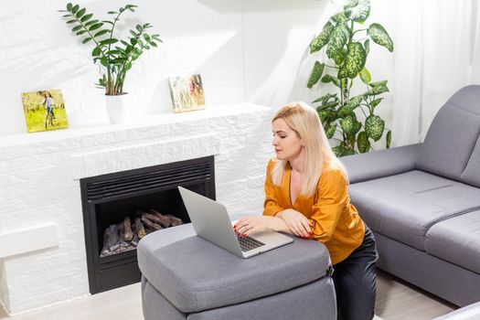 Beautiful young woman working on her laptop at home