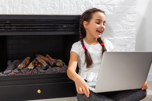 Kids distance learning. Cute little girl using laptop at home. Education, online study, home studying, technology, science, future, distance learning, homework, schoolgirl children lifestyle concept.
