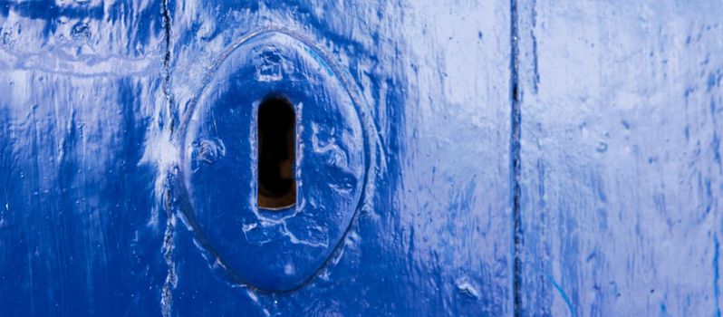 keyhole in an old door with an interesting texture, a remnant of an old entrance security, vintage