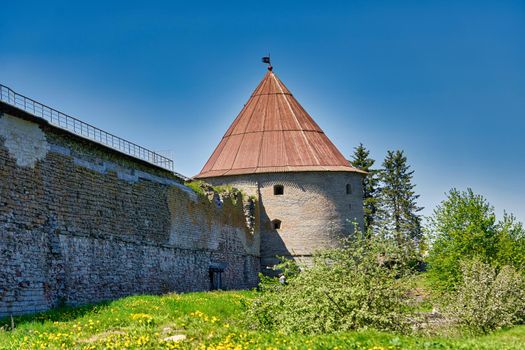 View of the old stone fortress with a watchtower. Fortress Oreshek on a sunny summer day