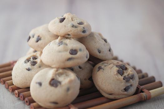 stack of chocolate cookies on wooden background.
