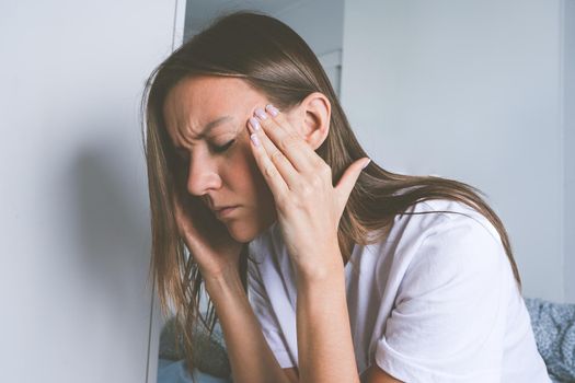 Young woman suffering from head pain, tension headache, migraine or depression. High quality photo