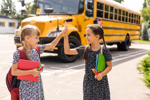 Back to school. First day of school. Two teenage girs at the school feeling happy and excited