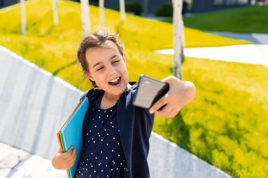 Success Concept. Glad schoolgirl holding textbooks