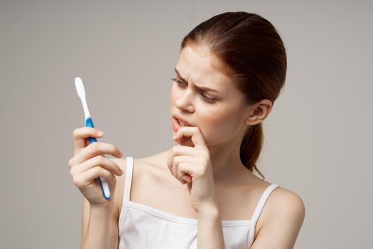 woman with a toothbrush in hand morning hygiene studio lifestyle. High quality photo