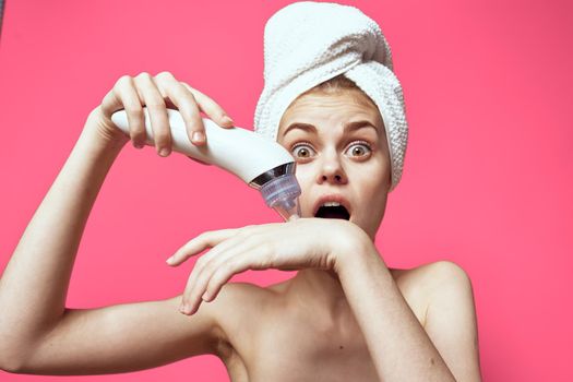 woman with bare shoulders with a towel on her head cleaning the skin. High quality photo