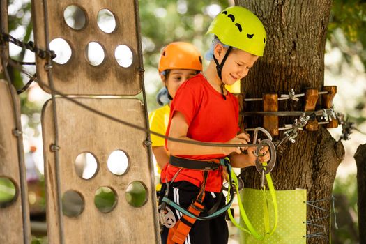 Boy climber walks on the rope bridge