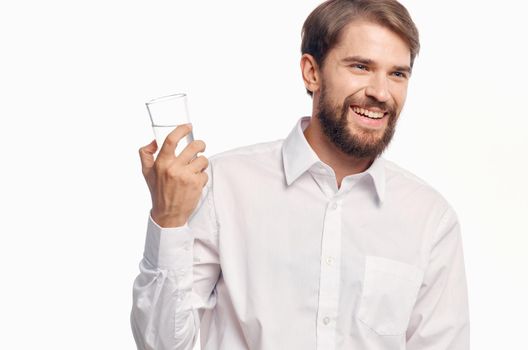 handsome man drinking water light background. High quality photo