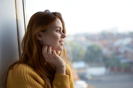 beautiful woman in a yellow sweater at home. High quality photo