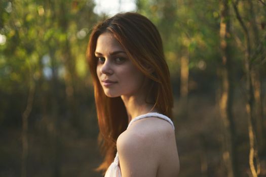 Woman in white dress nature walk forest summer trees. High quality photo