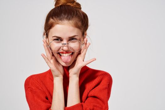 portrait of a woman in a red sweater Lifestyle Studio fun model. High quality photo