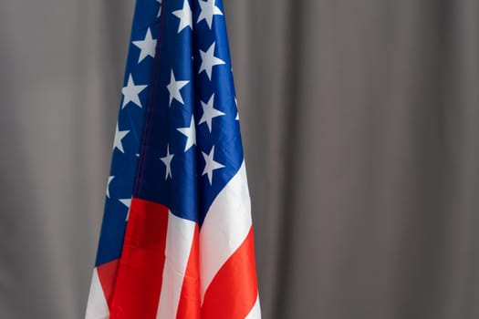Closeup of American flag on grey background.
