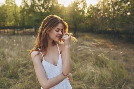 cheerful woman nature freedom in the field walk fresh air. High quality photo