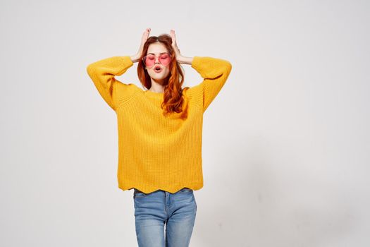 pretty woman in a yellow sweater hairstyle posing Studio fun model. High quality photo