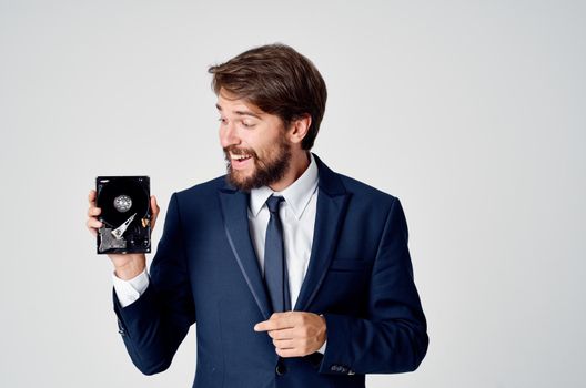 a man in a suit with a hard drive information recovery emotions. High quality photo
