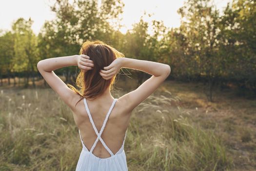 cheerful woman nature freedom in the field walk fresh air. High quality photo