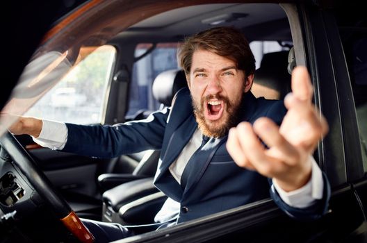 bearded man in a suit in a car a trip to work service. High quality photo