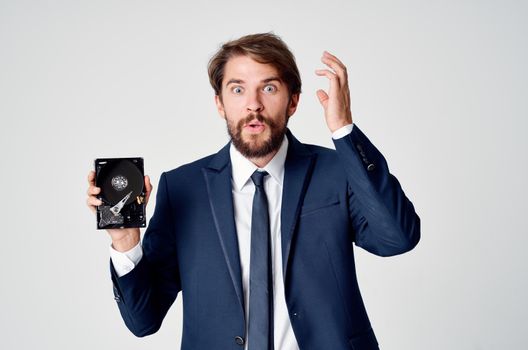 emotional business man with hard drive on computer technology. High quality photo