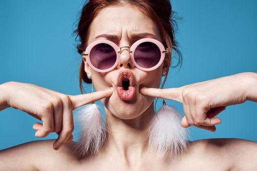 cheerful woman with bare shoulders round glasses decoration emotions. High quality photo