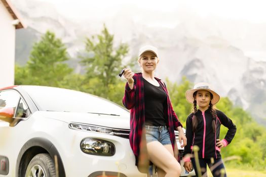 Happy driver woman against mountains background. Summer vacations concept.