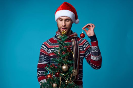 Cheerful man in a santa hat Christmas decorations holiday New Year isolated background. High quality photo