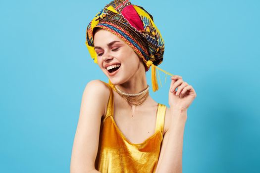 cheerful woman ethnicity multicolored headscarf makeup glamor isolated background. High quality photo