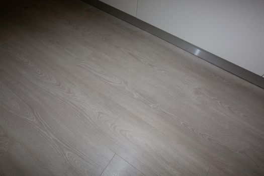 New kitchen in renovated house with laminated timber flooring.