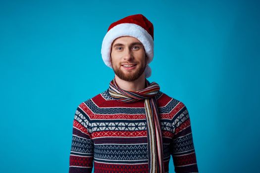 handsome man new year clothes christmas holiday blue background. High quality photo