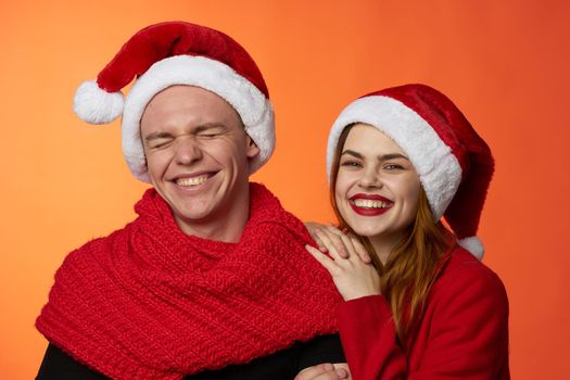 man and woman wearing christmas hats christmas holiday friendship. High quality photo