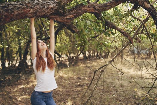 pretty woman sitting near a tree nature Lifestyle summer. High quality photo